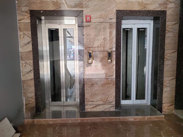Modern passenger elevator entrance with stainless steel doors