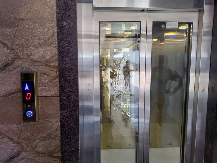 Glass elevator door project with call button panel